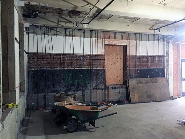 inside of a building under construction with wheelbarrows