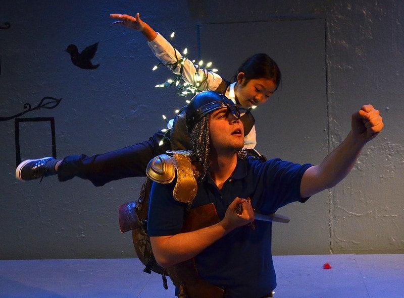 STAGE ACT: Child wrapped in fairy lights, balancing on an Adults shoulders 