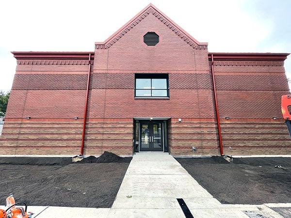 a 2-story building with brick exterior and a door in the center