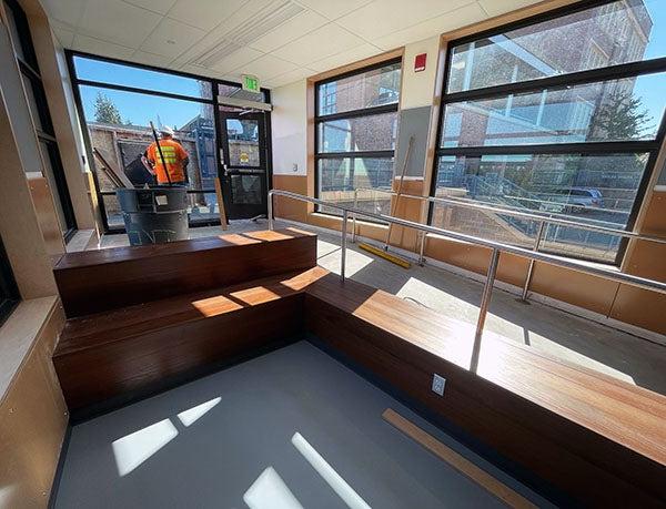 wood benches with a concrete ramp and windows